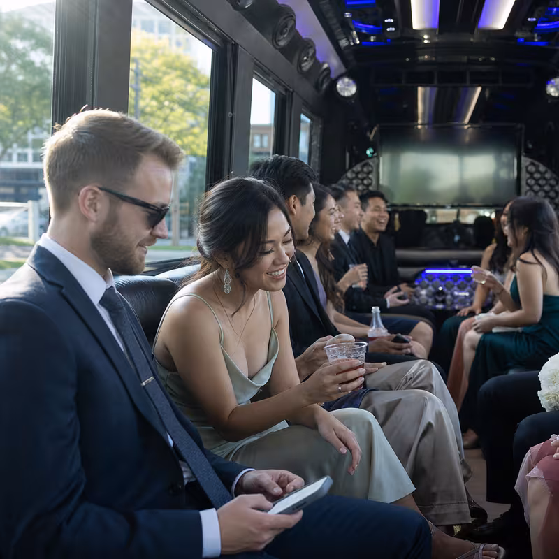 Wedding guests seated inside a Sacramento party bus