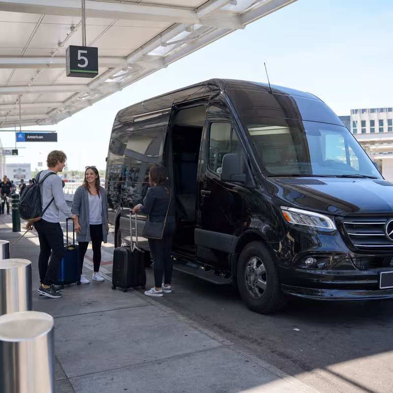 Group boarding a white charter bus for Airport Transportation transportation in Sacramento