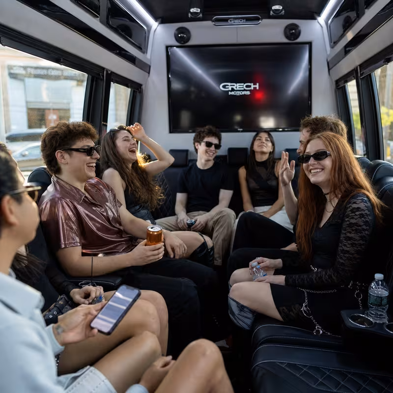Group boarding a white charter bus for Concert Transportation transportation in Sacramento