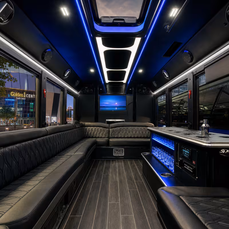 Party bus interior with wraparound leather seating and LED lighting in Sacramento
