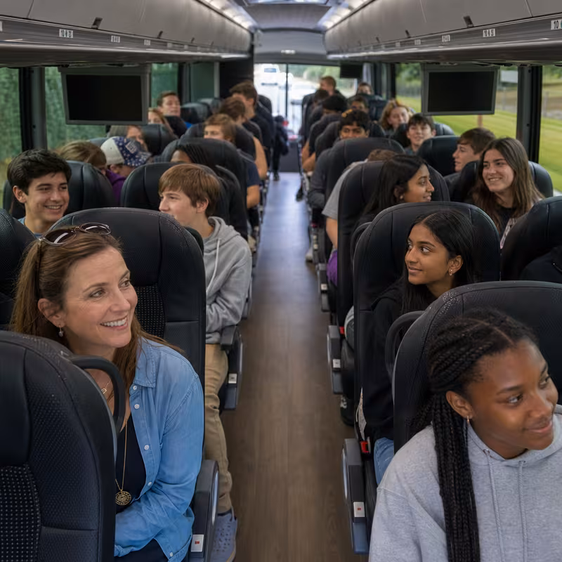 Group boarding a white charter bus for School Transportation transportation in Sacramento