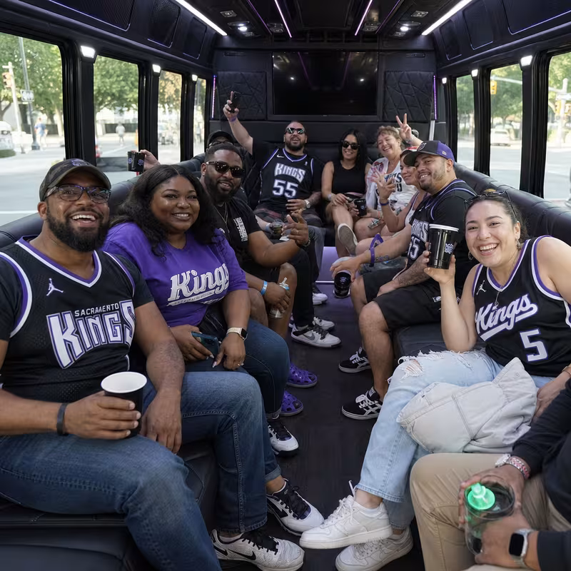 Group boarding a white charter bus for Sporting Event Transportation transportation in Sacramento