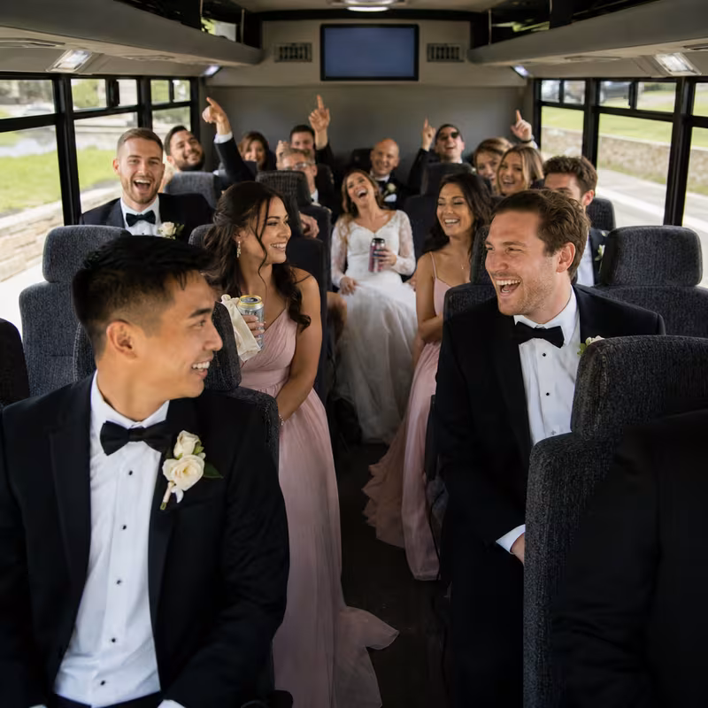 Group boarding a white charter bus for Wedding Transportation transportation in Sacramento