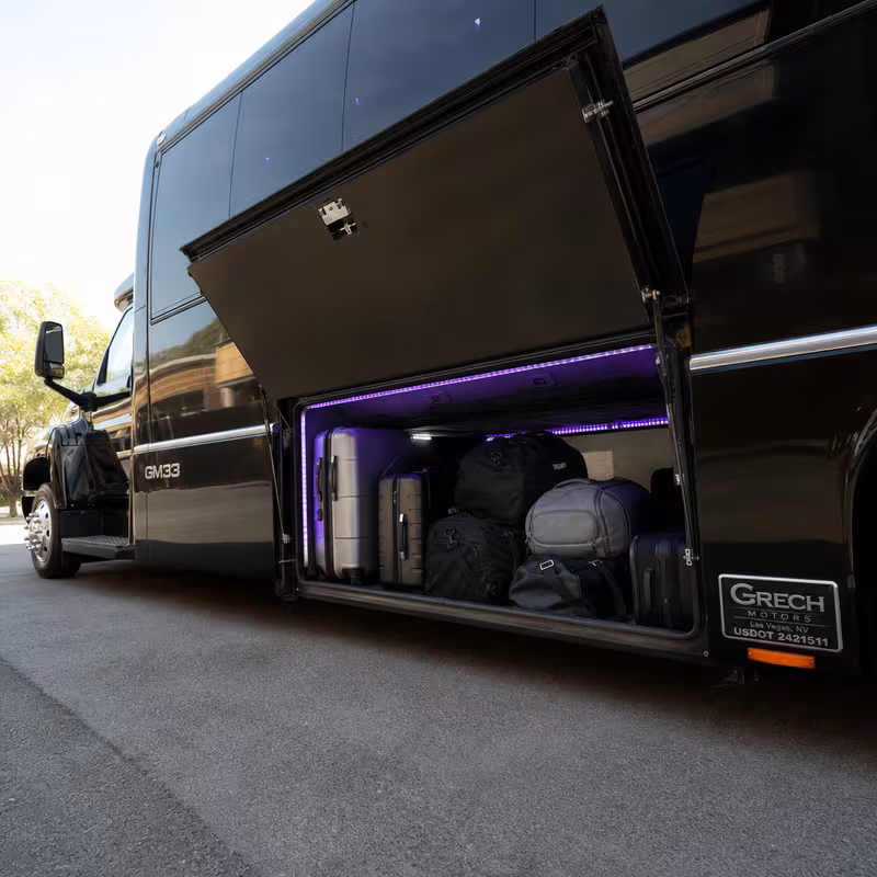 Party bus interior with wraparound leather seating and LED lighting in Sacramento