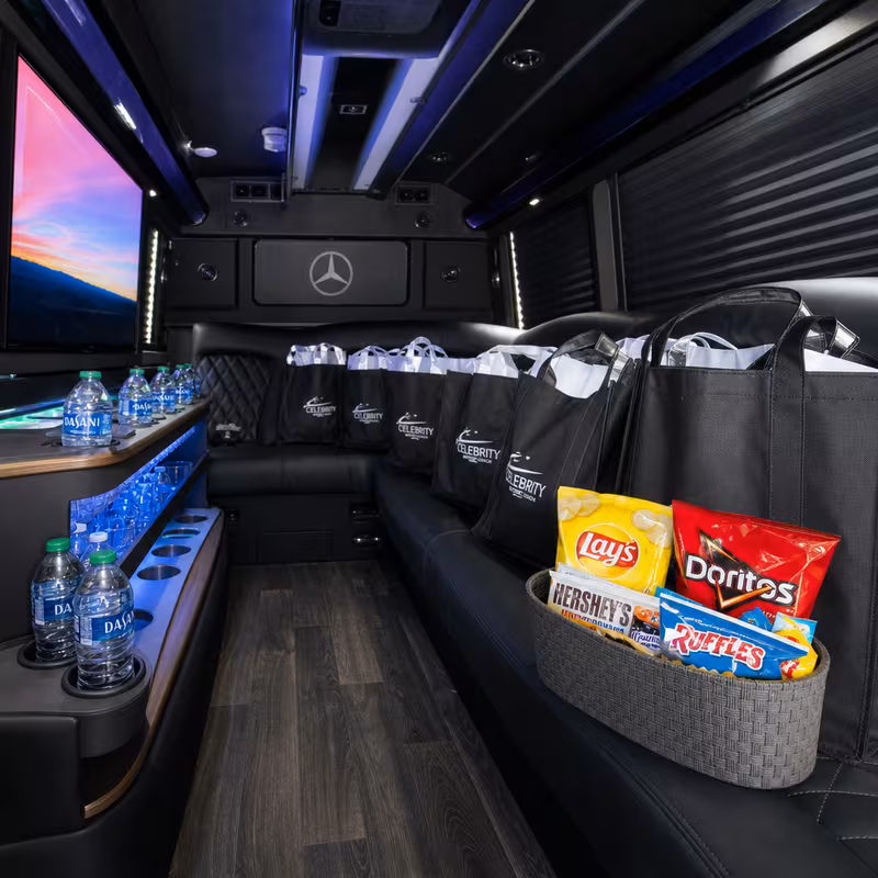 Party bus interior with wraparound leather seating and LED lighting in Sacramento
